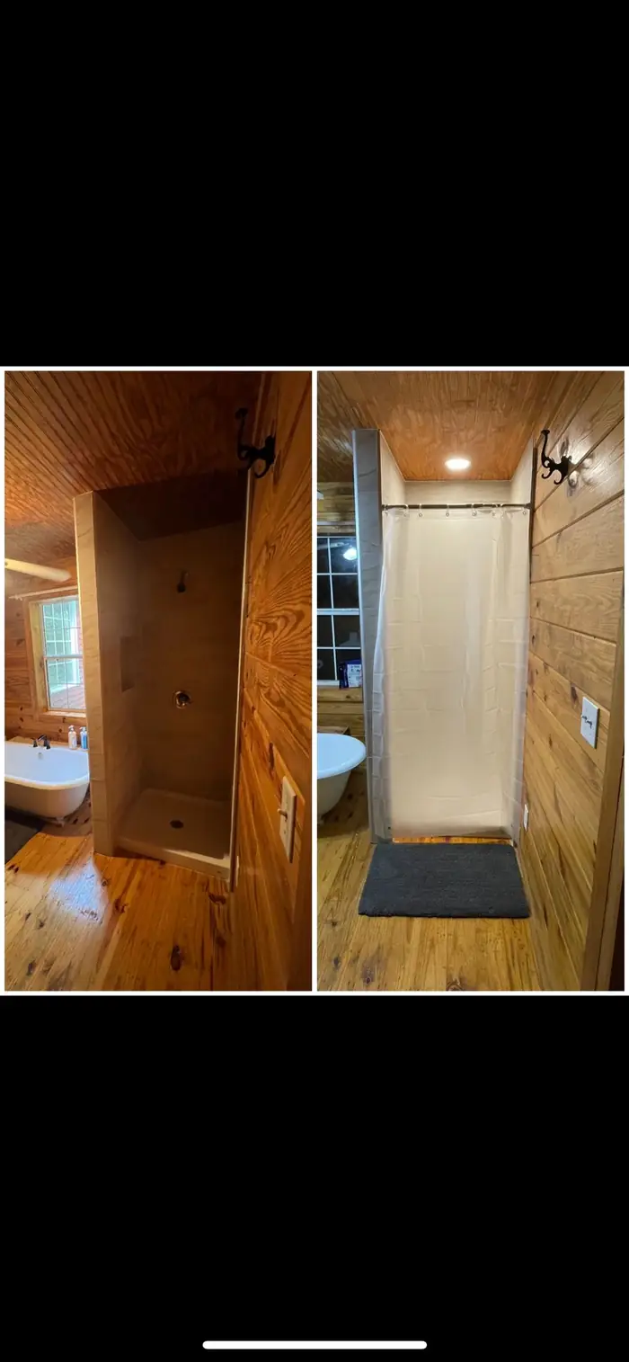 A bathroom with a tiled shower surround and wood-lined walls, beside a freestanding tub